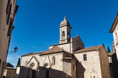 Low angle view of buildings against clear blue sky