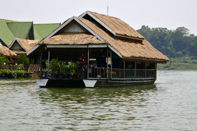 Houseboats on lake against sky