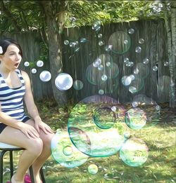 Woman sitting in swimming pool