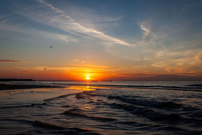 Scenic view of sea against sky during sunrise