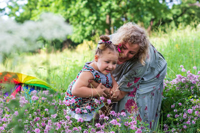 Cute girl with flowers on field