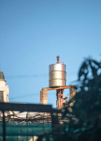 Low angle view of factory against clear blue sky