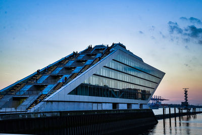 Low angle view of modern hamburg cruise terminal building against sky