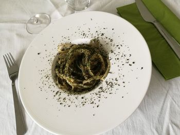 High angle view of garnished noodles in plate on table