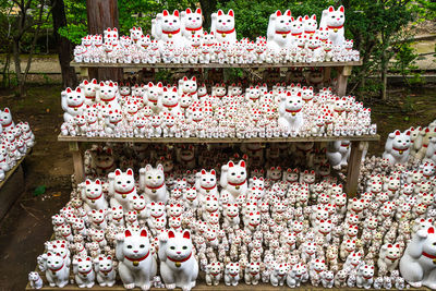 Thousands of maneki-neko statues displayed in the garden of gotokuji temple in tokyo, japan