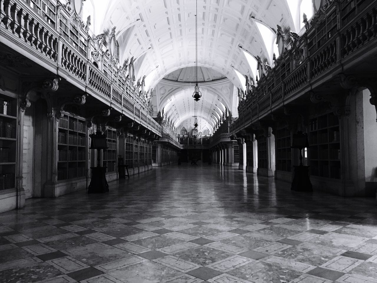 architecture, built structure, ceiling, indoors, lighting equipment, the way forward, illuminated, architectural column, tiled floor, corridor, diminishing perspective, flooring, empty, in a row, building exterior, walkway, incidental people, building, column, arch