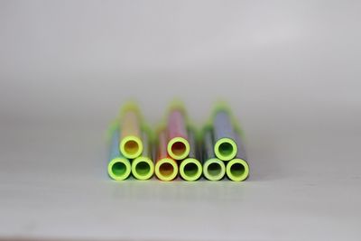Close-up of green colored pencils over white background