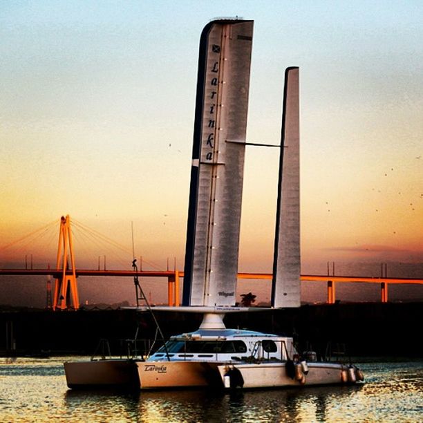 transportation, water, sunset, nautical vessel, sea, waterfront, built structure, mode of transport, architecture, travel, boat, bridge - man made structure, river, sky, suspension bridge, sailing, connection, engineering, travel destinations, clear sky