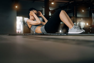 Midsection of woman sitting at home