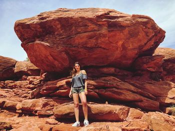 Full length of woman standing on rock