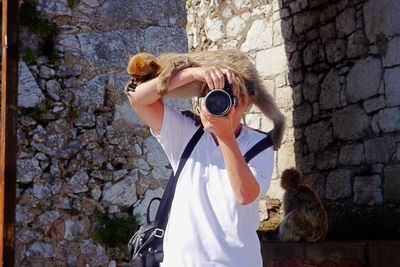 Portrait of woman photographing camera