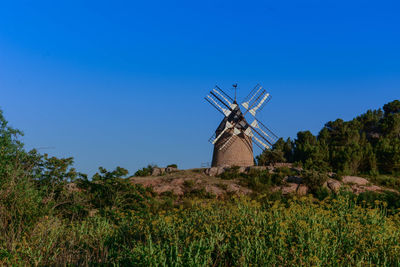 Traditional windmill on field against sky