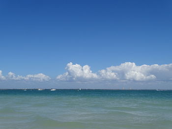 Scenic view of sea against blue sky