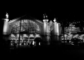 People in illuminated building at night