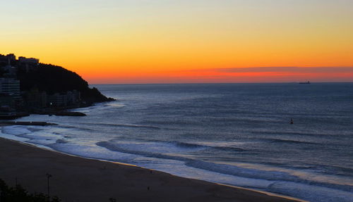 Scenic view of sea against orange sky