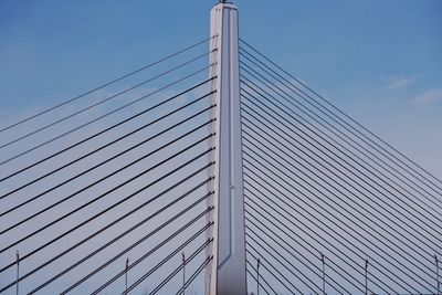 Low angle view of suspension bridge against sky