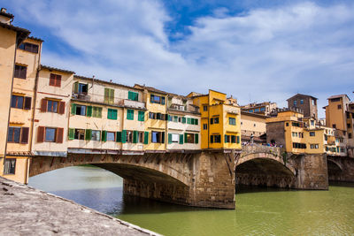 Tourists at ponte vecchio a medieval stone  bridge over the arno river in florence