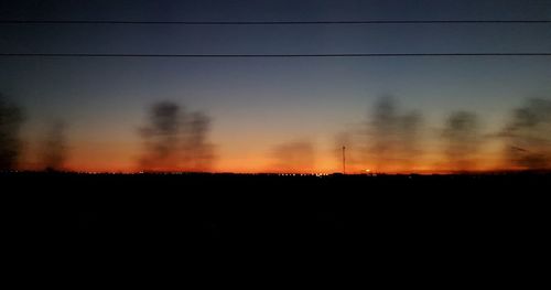 Silhouette landscape against sky during sunset