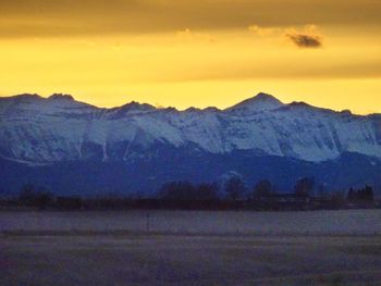 Scenic view of snow covered mountains against sky