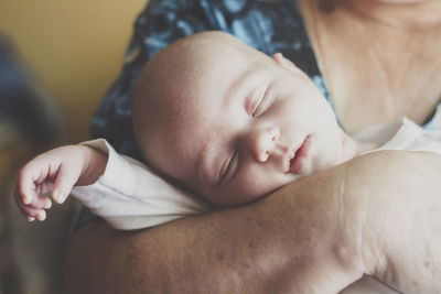 Portrait of baby boy sleeping in grandmother's rams