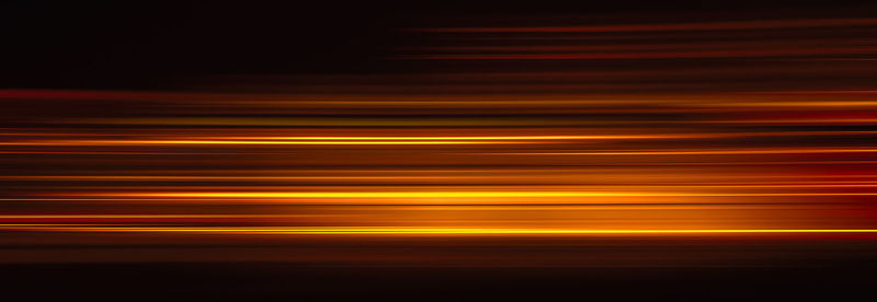 Blurred motion of light trails against black background