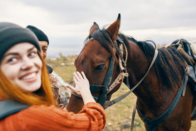 Portrait of young woman with horse