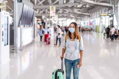 Full length portrait of woman walking in bus