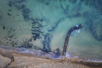 High angle view of waves splashing on beach