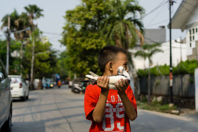 Full length of boy standing on street