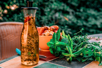 Close-up of vegetables and olive oil on table