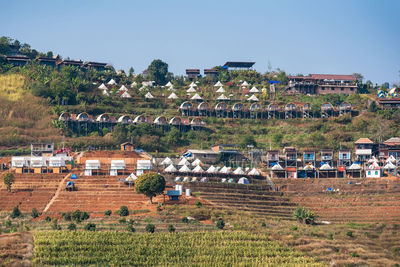 Houses on field against sky