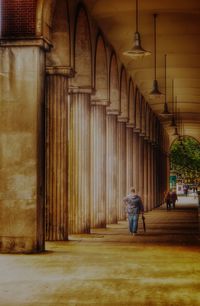 Rear view of woman walking on building