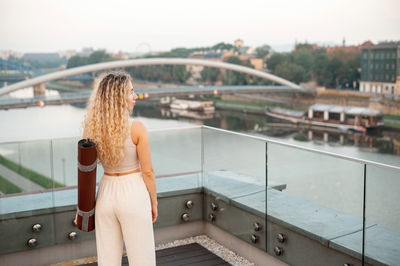 Portrait of smiling young woman standing in city