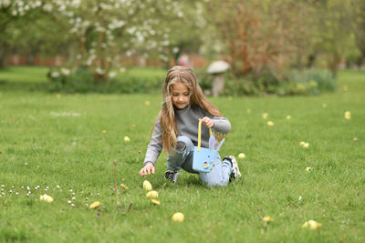 Girl looking for eggs in a bag for easter