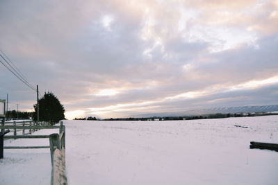 Snow covered field against sky