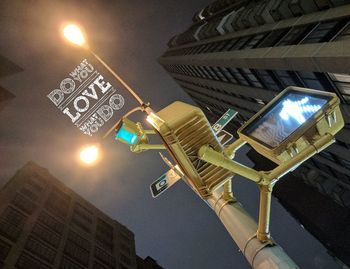 Low angle view of illuminated skyscraper at night