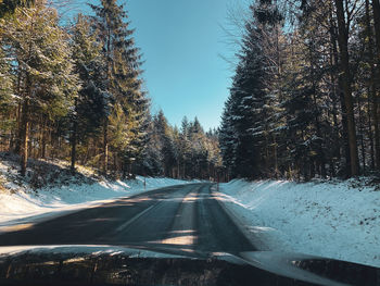 Road seen through car windshield during winter