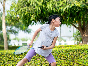 Girl playing badminton in playground