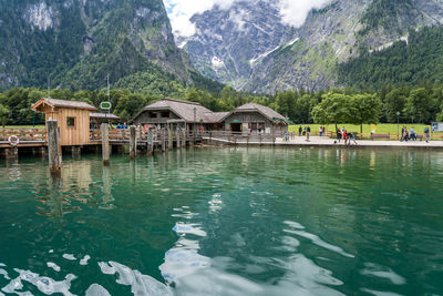 Houses by lake against mountains