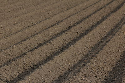 Full frame shot of tire tracks on field