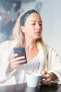 Portrait of young woman using smart phone