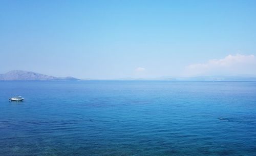 Scenic view of sea against blue sky