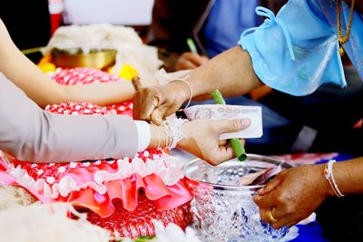 Close-up of people holding ice cream