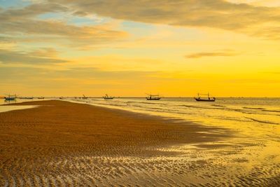 Scenic view of beach against sky during sunset