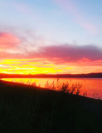 Scenic view of sea against romantic sky at sunset