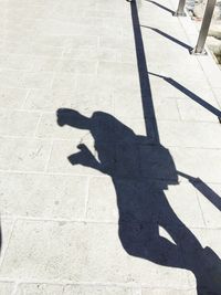 Shadow of person on footpath