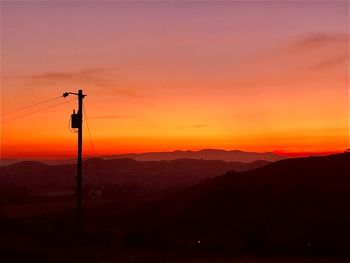 Silhouette mountain range against romantic sky at sunset