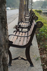 Close-up of old bench in park