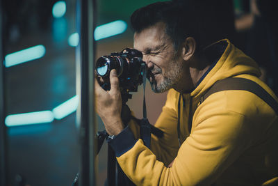 Full length portrait of young man photographing