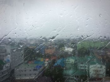 Full frame shot of wet glass window in rainy season